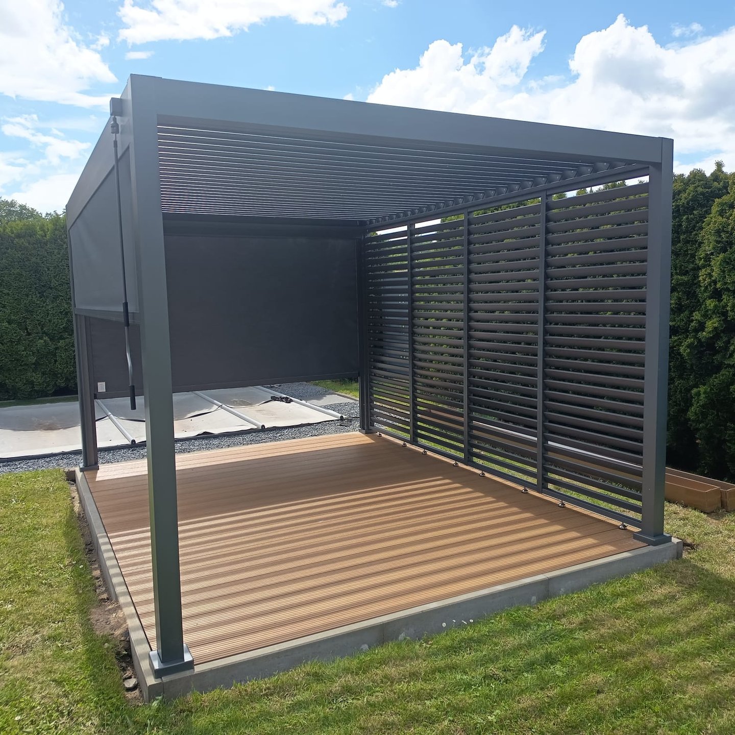 Begrünter Gartenpavillon mit Holzdielen und Jalousien an sonnigem Tag